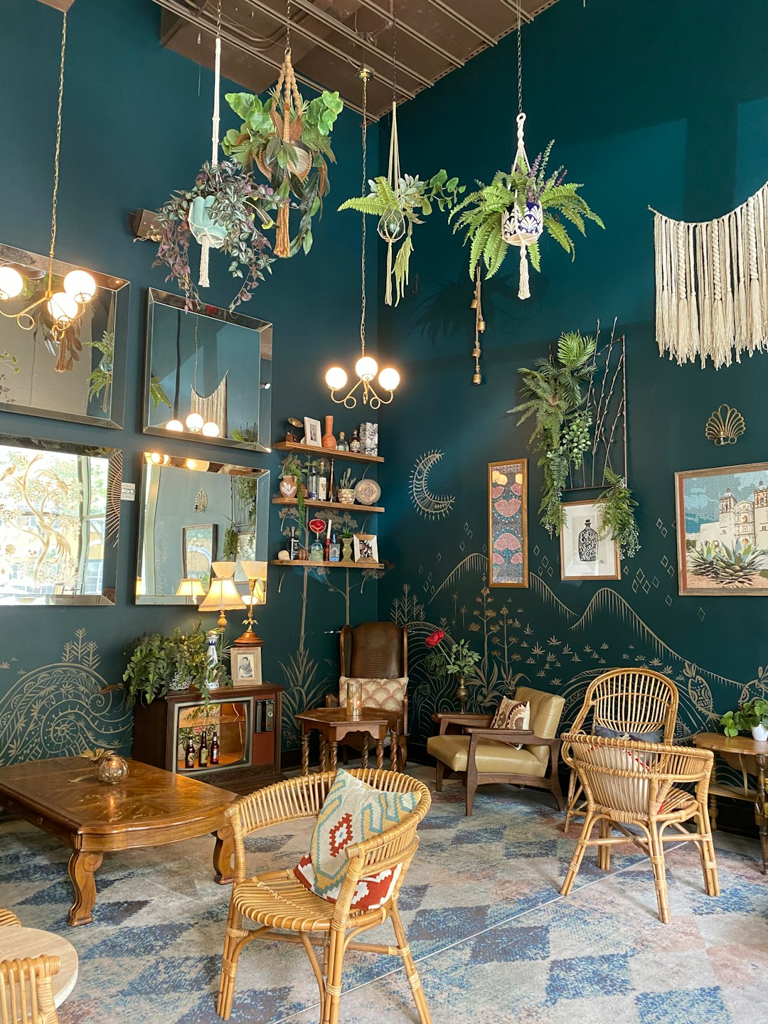 Cozy room corner with teal walls, plants, and eclectic furniture.
